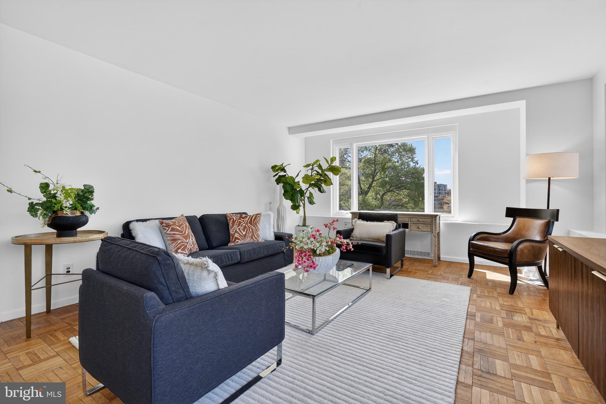 2475 Virginia Avenue Northwest, Unit 429 Washington, DC 20037 - Photo 3 of 35 a living room with furniture and a large window