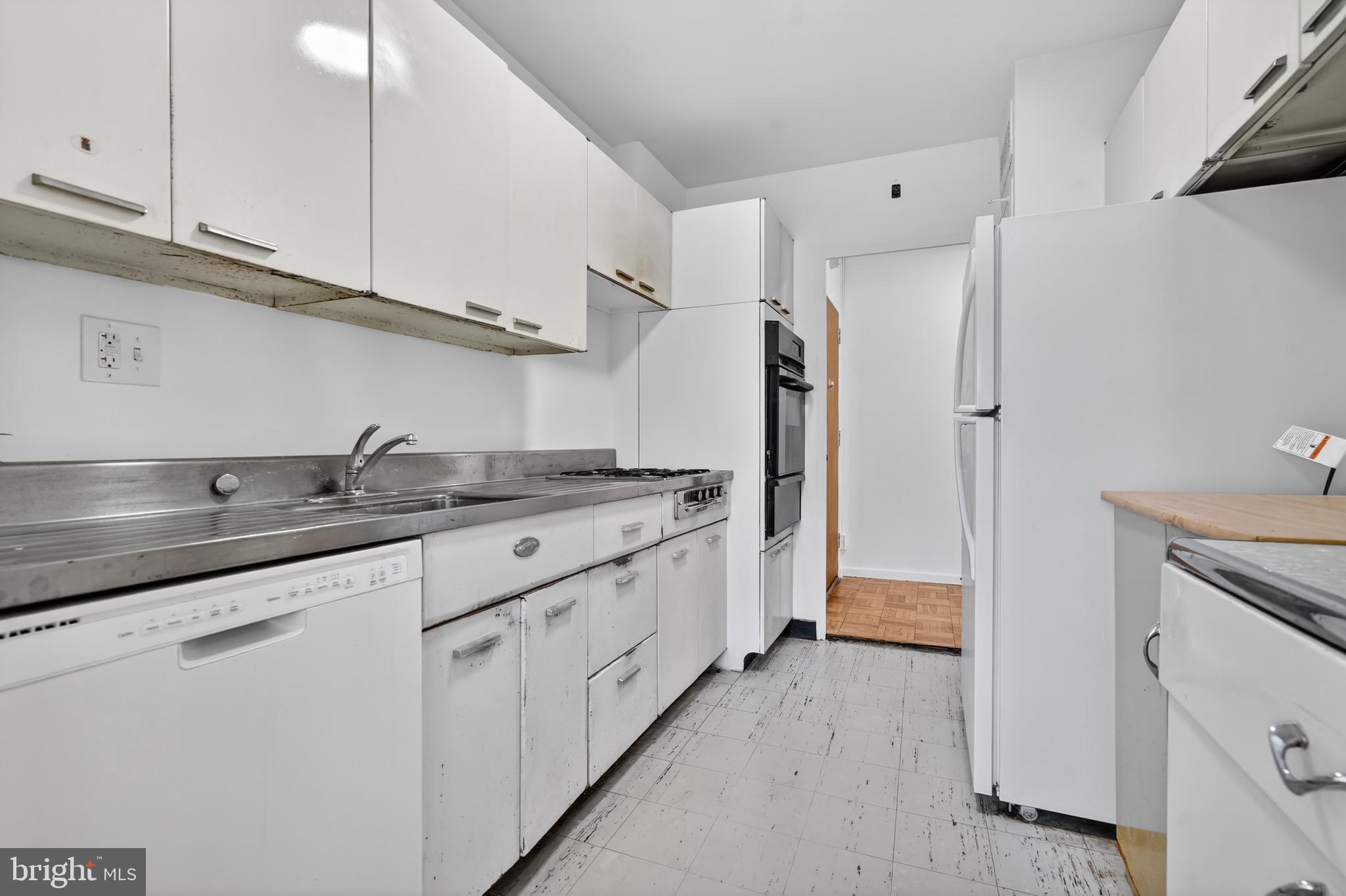 2475 Virginia Avenue Northwest, Unit 429 Washington, DC 20037 - Photo 8 of 35 a kitchen with granite countertop cabinets stainless steel appliances and a counter space
