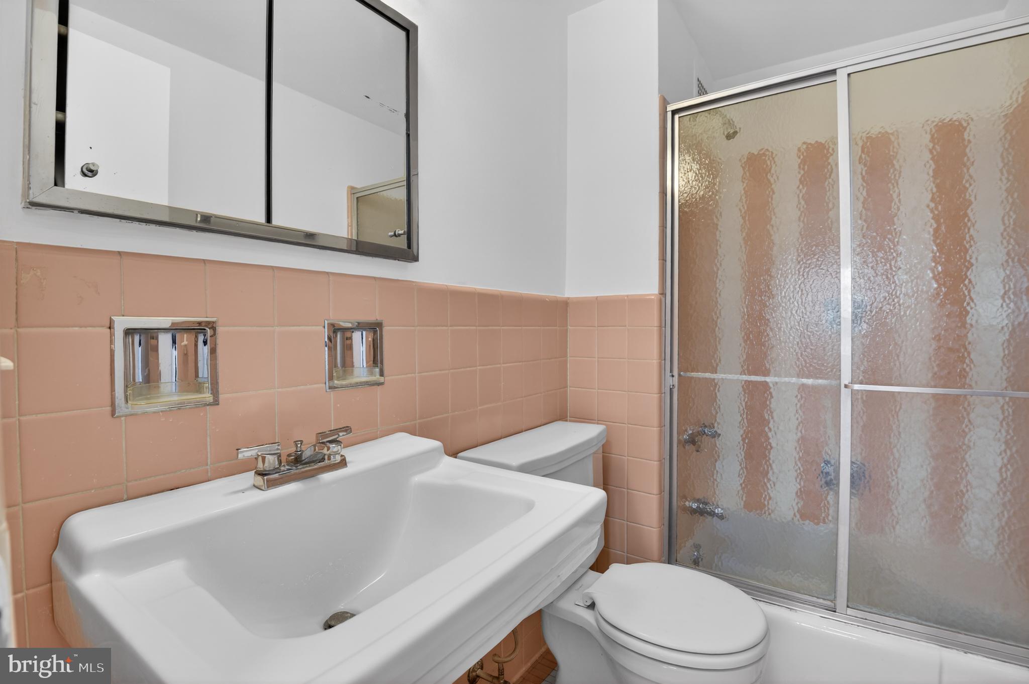 2475 Virginia Avenue Northwest, Unit 429 Washington, DC 20037 - Photo 8 of 27 a bathroom with a sink a toilet and shower