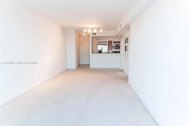 a kitchen with a refrigerator and a stove