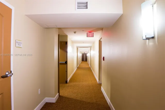 a living room with furniture and a lamp