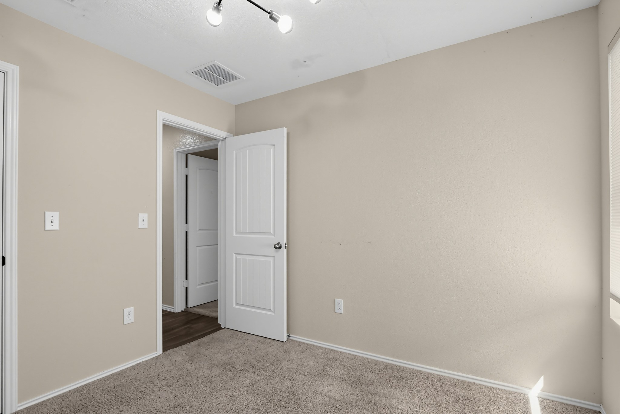 11810 Pyrite Road Manor, TX 78653 - Photo 6 of 38 Soft carpeting underfoot anchors this versatile space featuring neutral walls and structured panel doors.