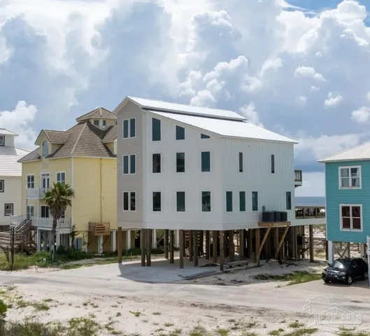 an aerial view of a house with a yard and sitting area