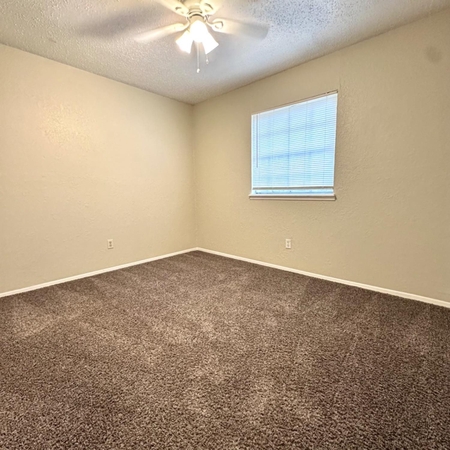 9107 Boston Avenue Lubbock, TX 79423 - Photo 11 of 14 an empty room with a window