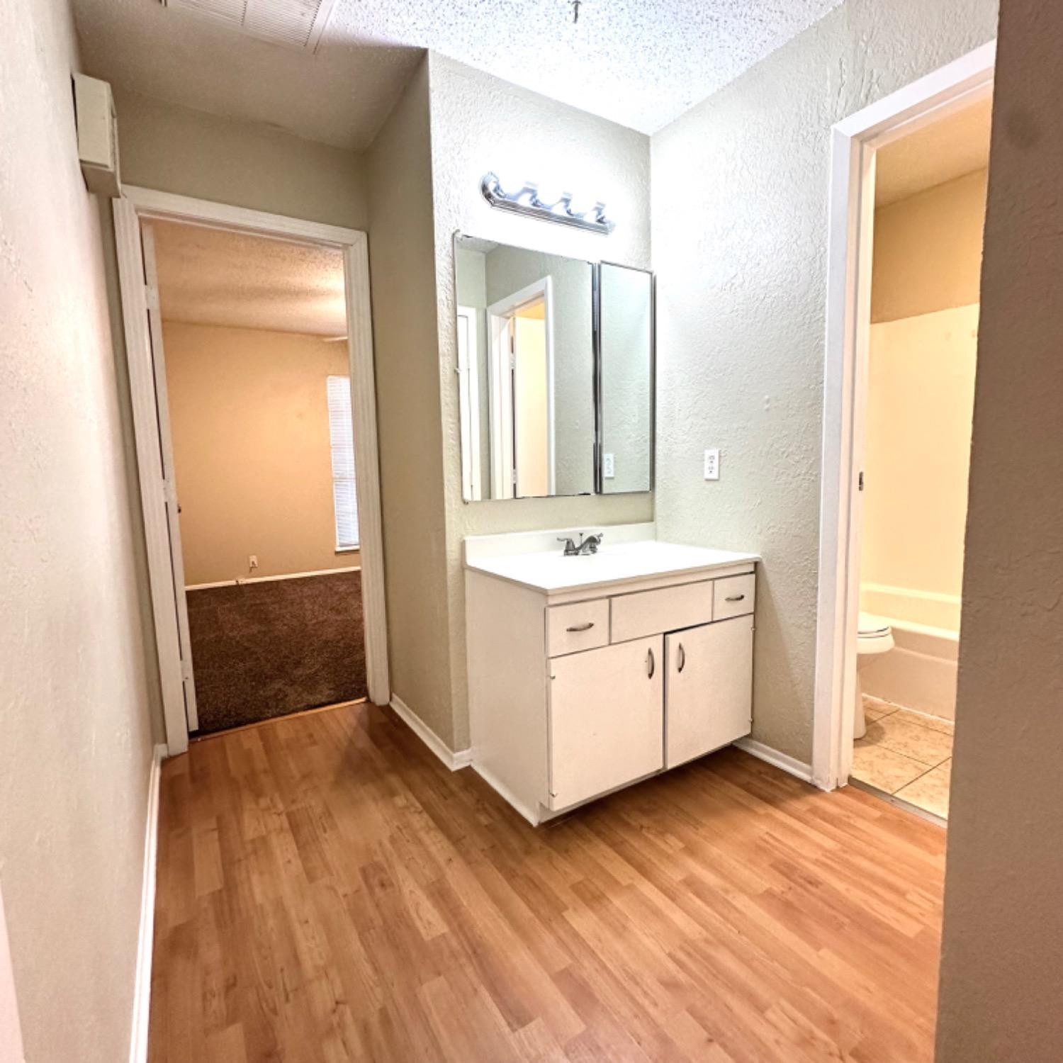 9107 Boston Avenue Lubbock, TX 79423 - Photo 12 of 14 a bathroom with a double vanity sink and mirror