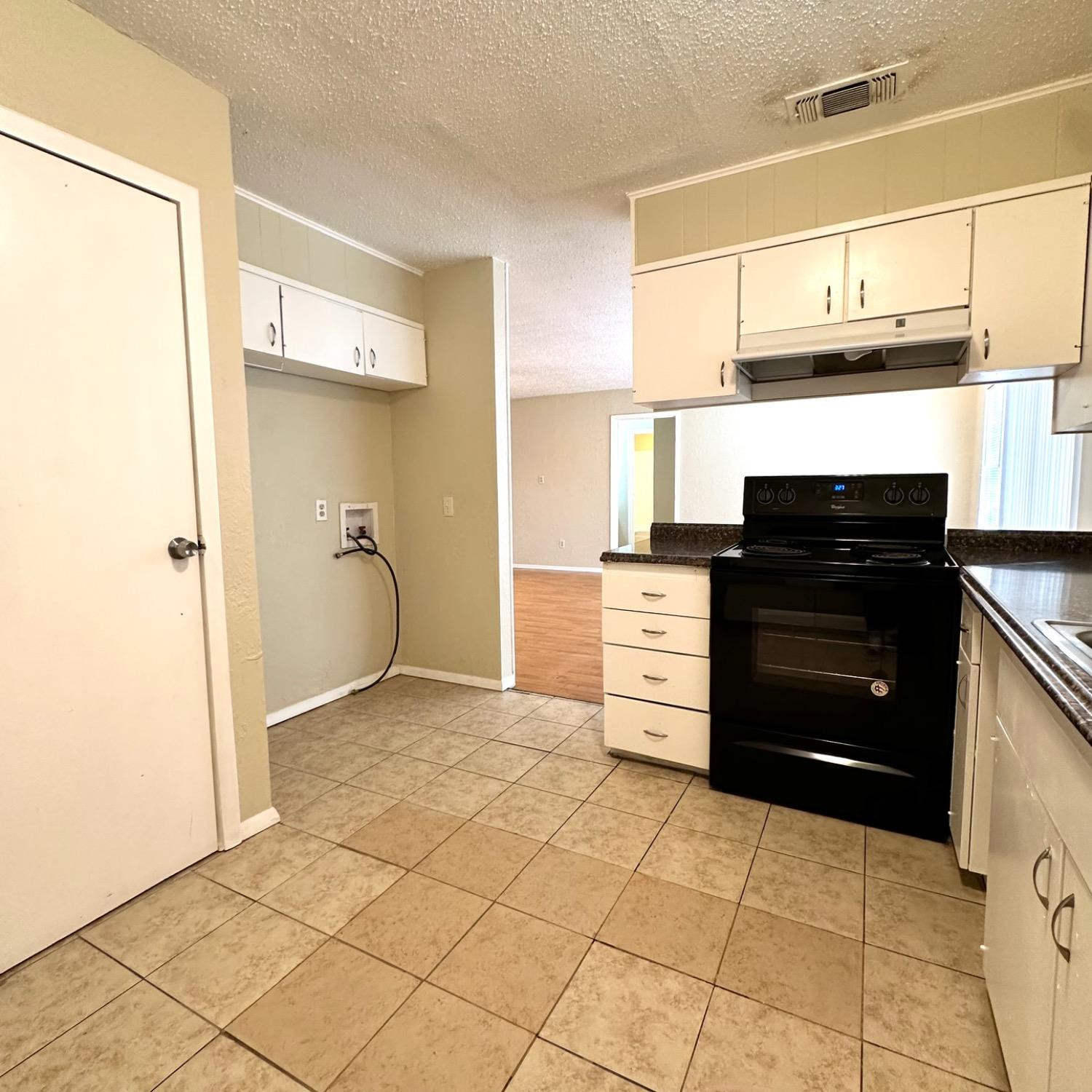 9107 Boston Avenue Lubbock, TX 79423 - Photo 4 of 14 a kitchen with a refrigerator and a stove top oven
