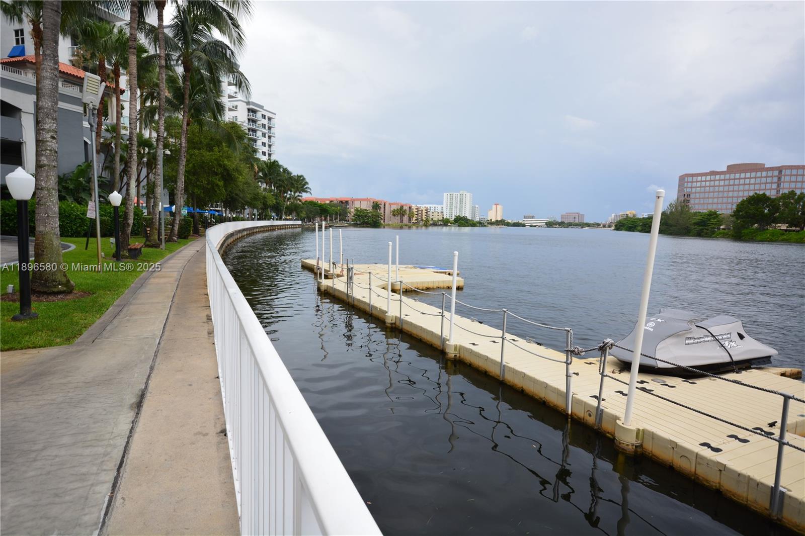 5077 Northwest 7th Street, Unit PH17 Miami, FL 33126 - Photo 21 of 25 a view of swimming pool with a lake and trees in the background