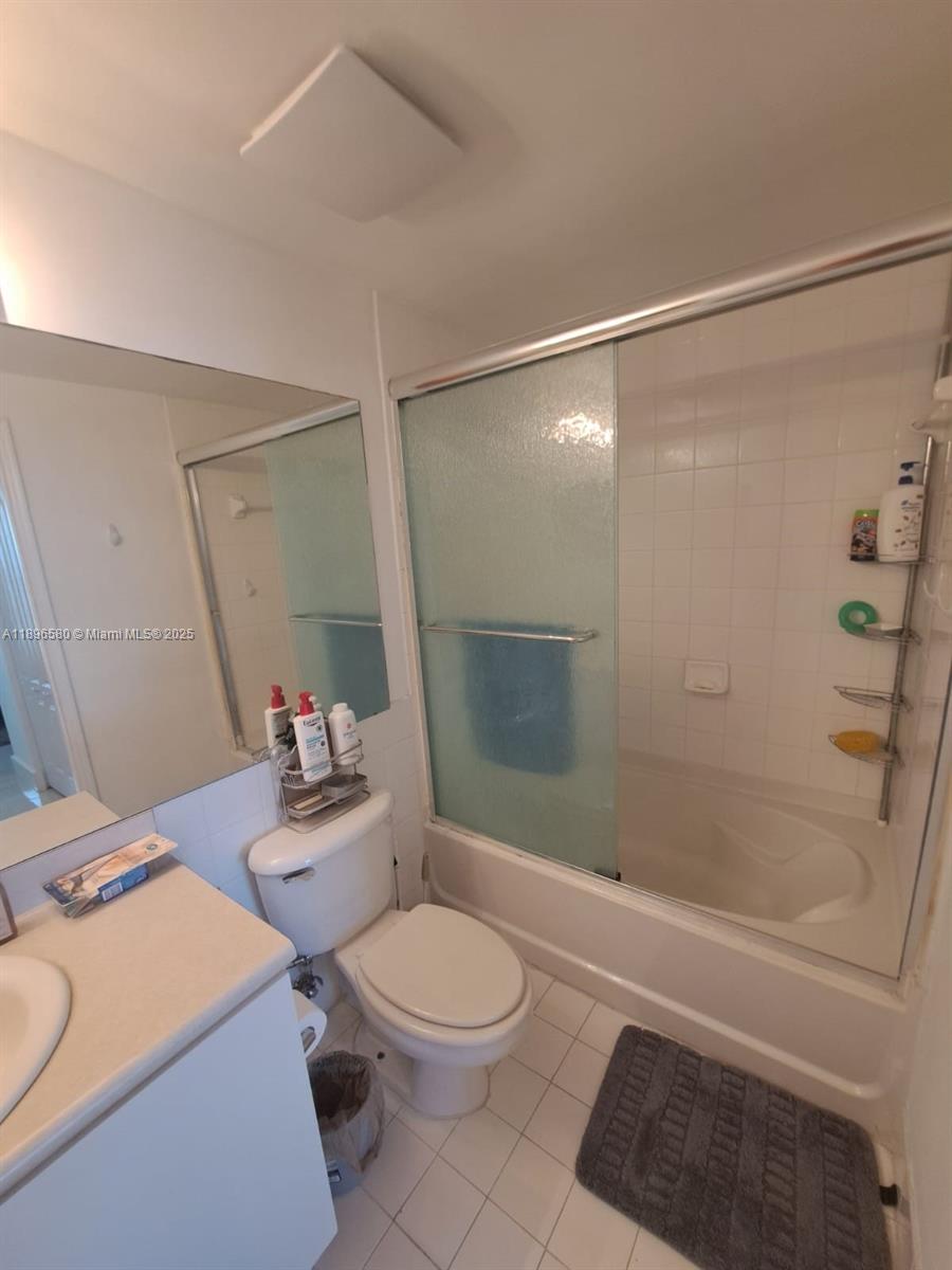 5077 Northwest 7th Street, Unit PH17 Miami, FL 33126 - Photo 5 of 25 a bathroom with a sink toilet and shower