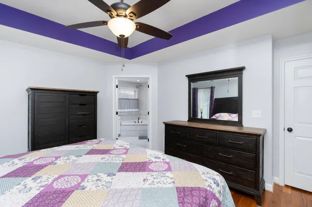 a bedroom with a bed and a dresser