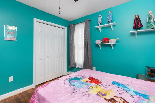 a bedroom with a bed and a dresser