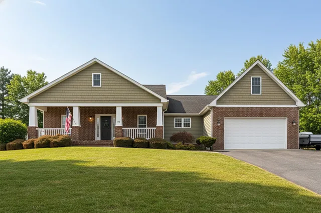 a front view of house with yard and green space