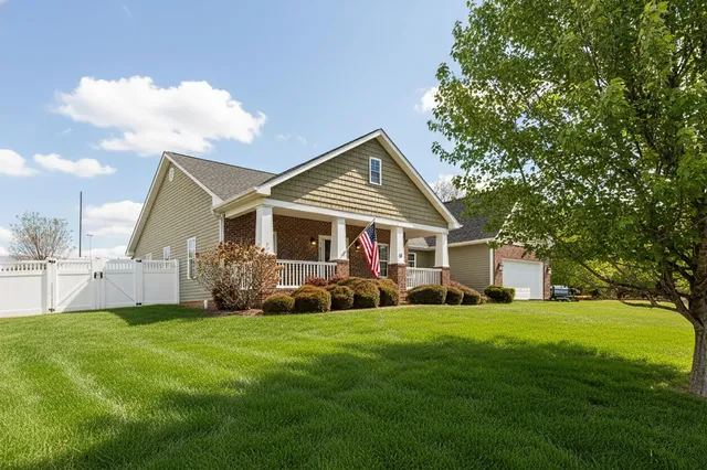 a front view of a house with yard and garage