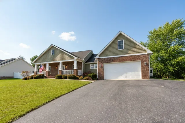 a living room with a fireplace a flat screen tv and a wooden floor