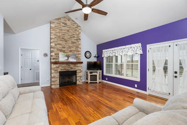a living room with furniture windows and a fireplace