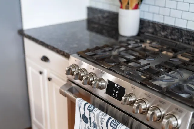 a close view of a stove and a kitchen counter space
