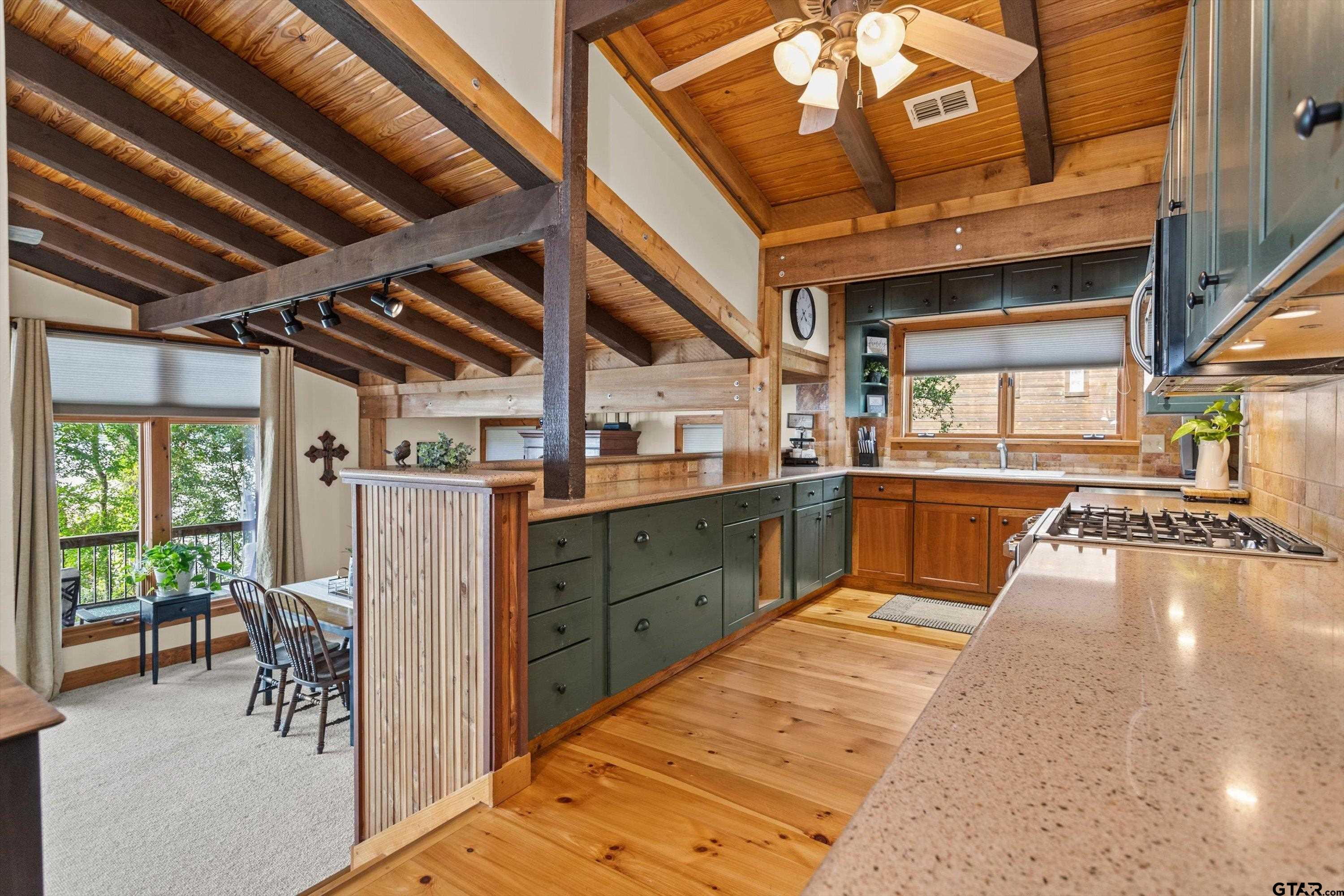 129 Tejas Trail Grapeland, TX 75844 - Photo 16 of 47 a kitchen with sink cabinets and outdoor living space