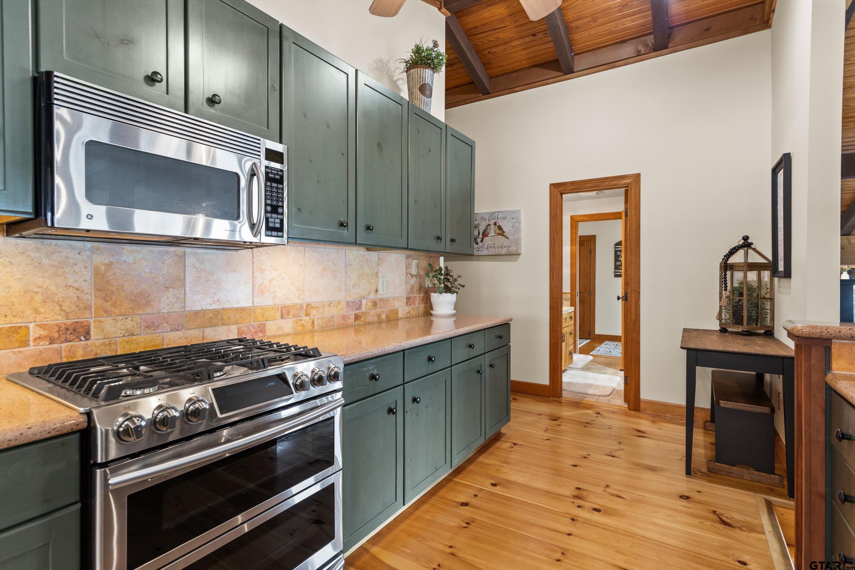 129 Tejas Trail Grapeland, TX 75844 - Photo 18 of 47 a kitchen with stainless steel appliances a stove a sink and a microwave