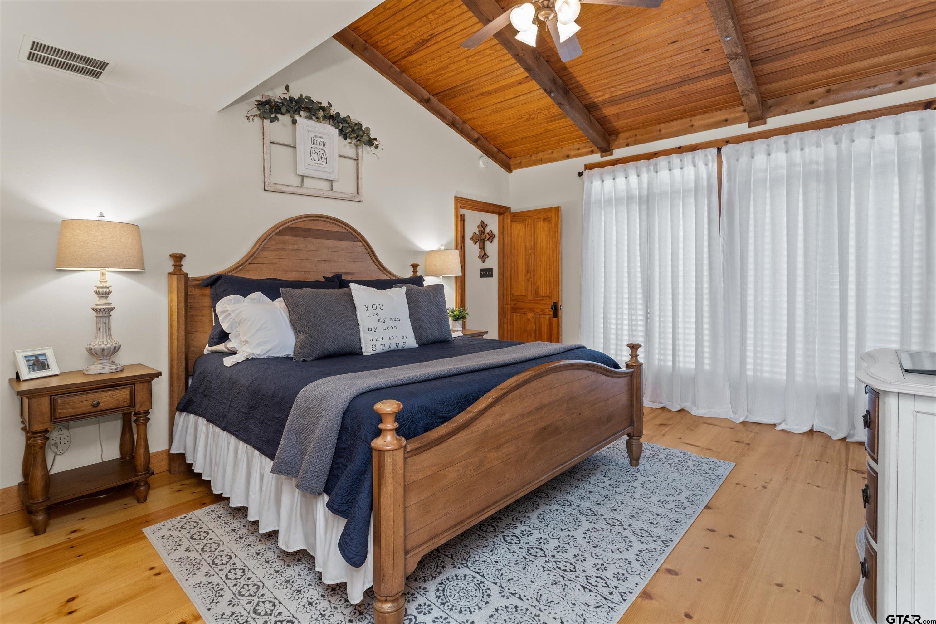 129 Tejas Trail Grapeland, TX 75844 - Photo 21 of 47 a bedroom with a bed lamp and a window