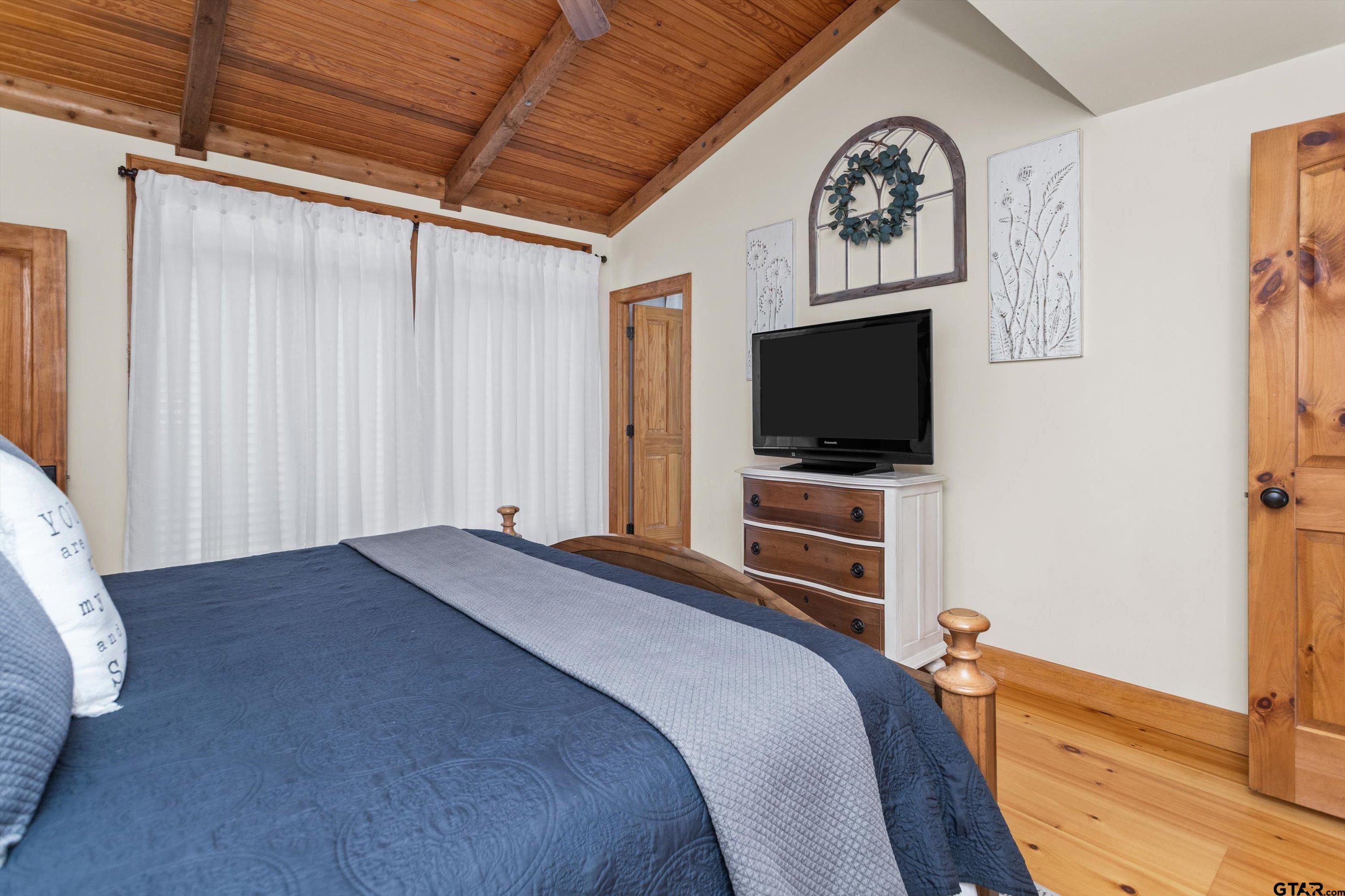 129 Tejas Trail Grapeland, TX 75844 - Photo 22 of 47 a bedroom with bed and a flat tv screen on dresser