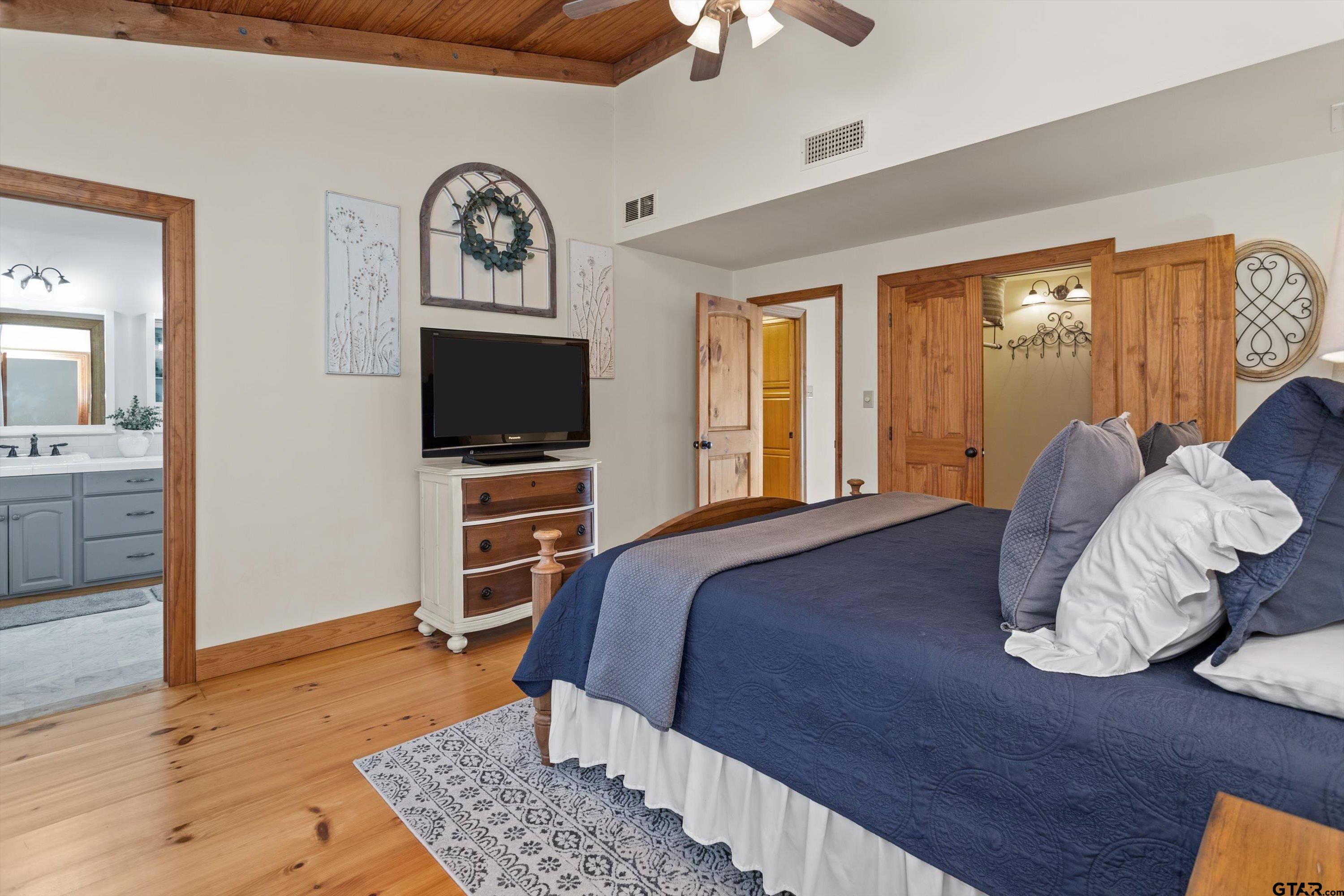 129 Tejas Trail Grapeland, TX 75844 - Photo 23 of 47 a bedroom with a bed and wooden floor