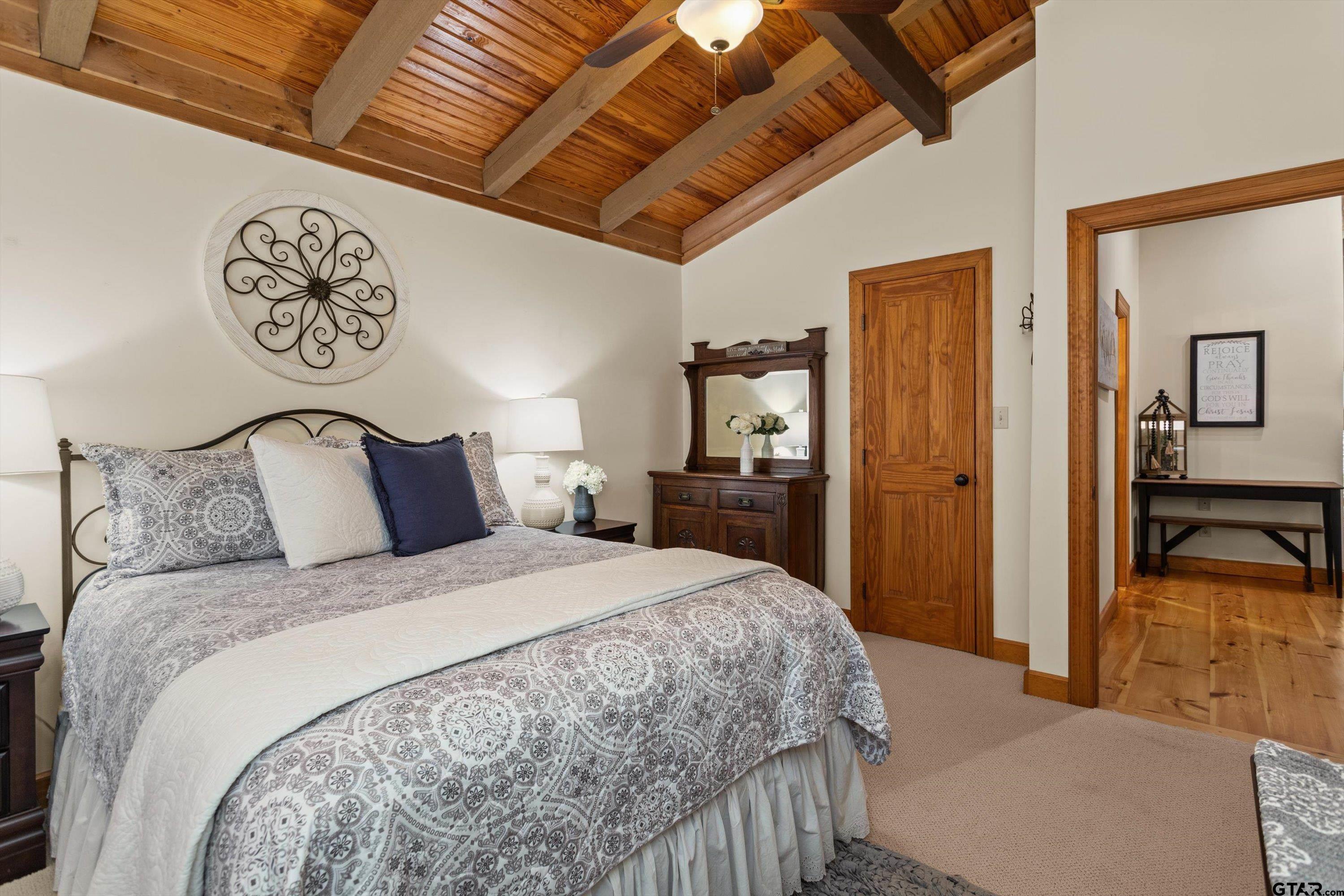 129 Tejas Trail Grapeland, TX 75844 - Photo 27 of 47 a bedroom with a large bed and a chandelier