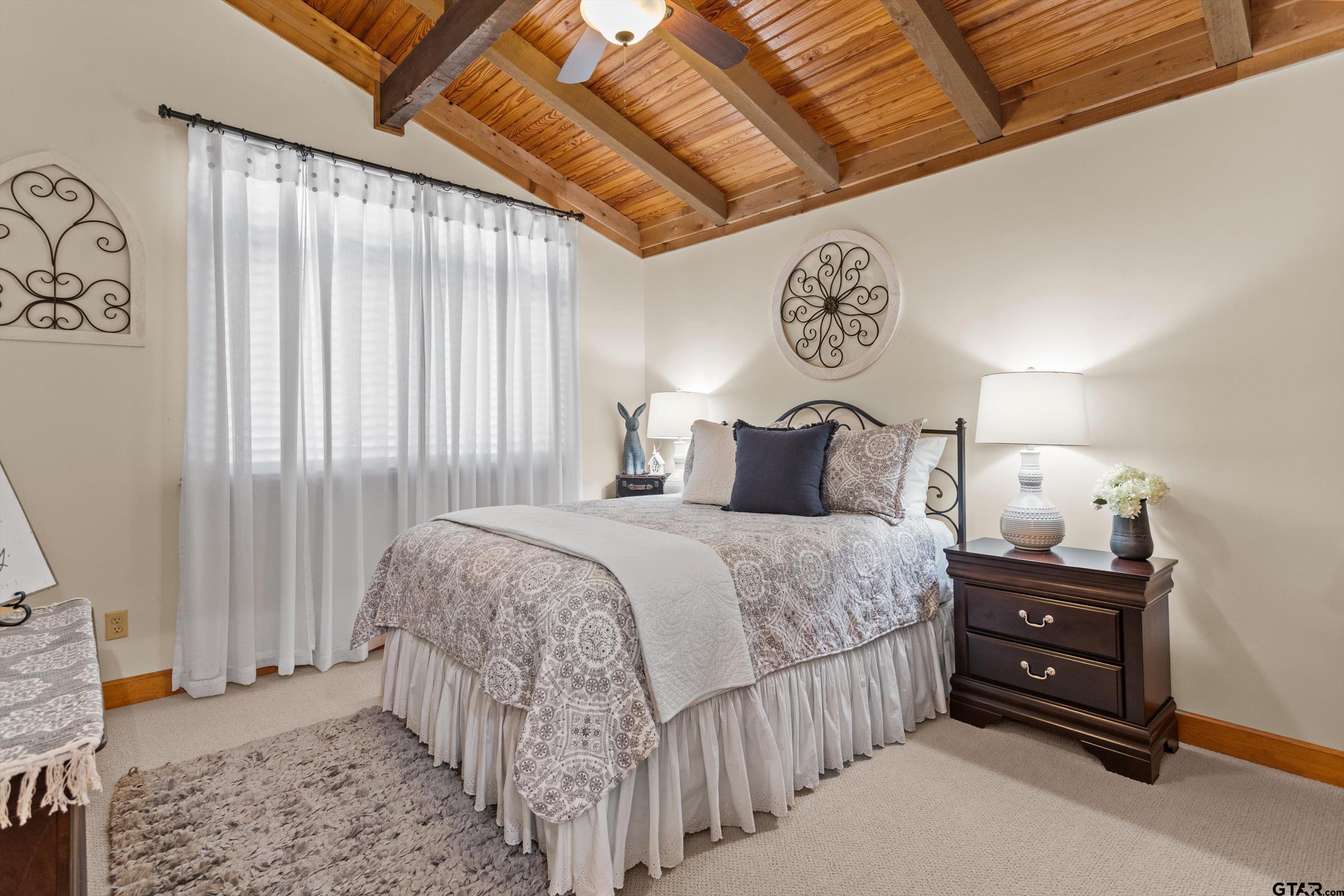 129 Tejas Trail Grapeland, TX 75844 - Photo 28 of 47 a bedroom with a bed and a chandelier