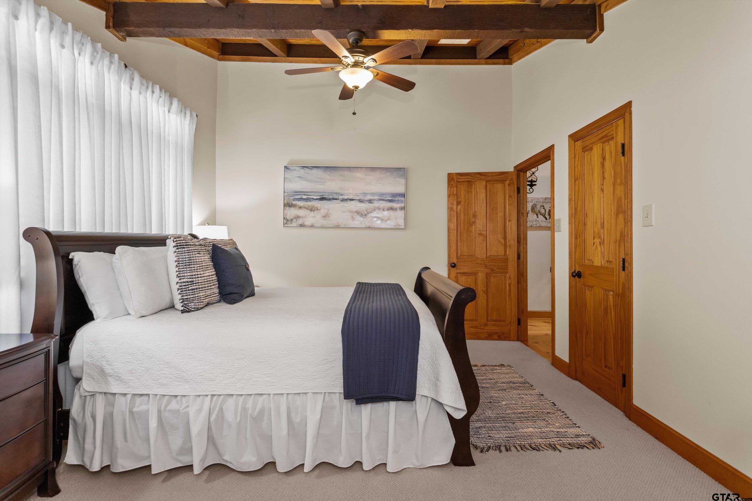 129 Tejas Trail Grapeland, TX 75844 - Photo 29 of 47 a bedroom with a bed lamp and a large window