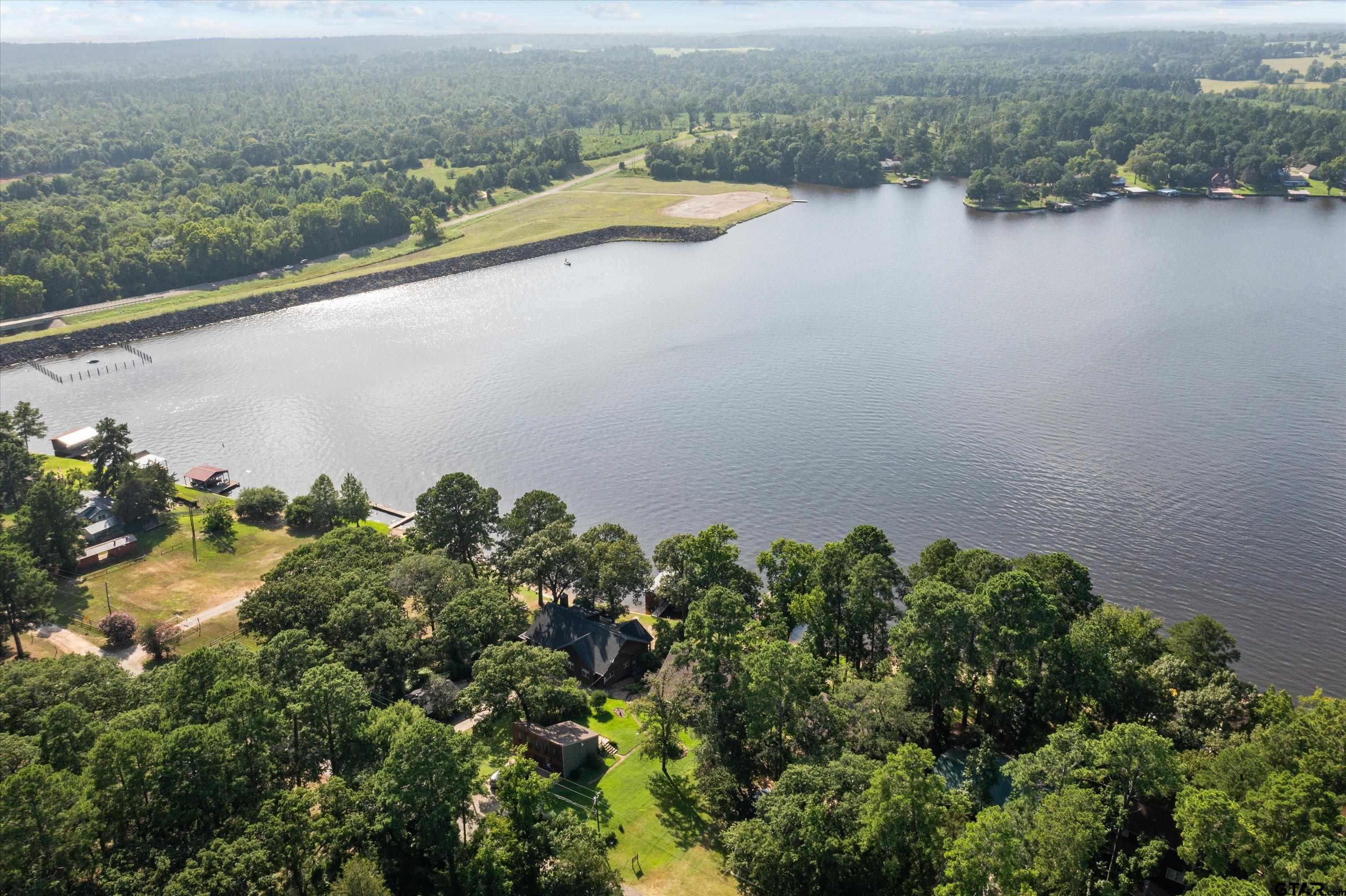 129 Tejas Trail Grapeland, TX 75844 - Photo 42 of 47 an aerial view of a residential houses with outdoor space and lake view