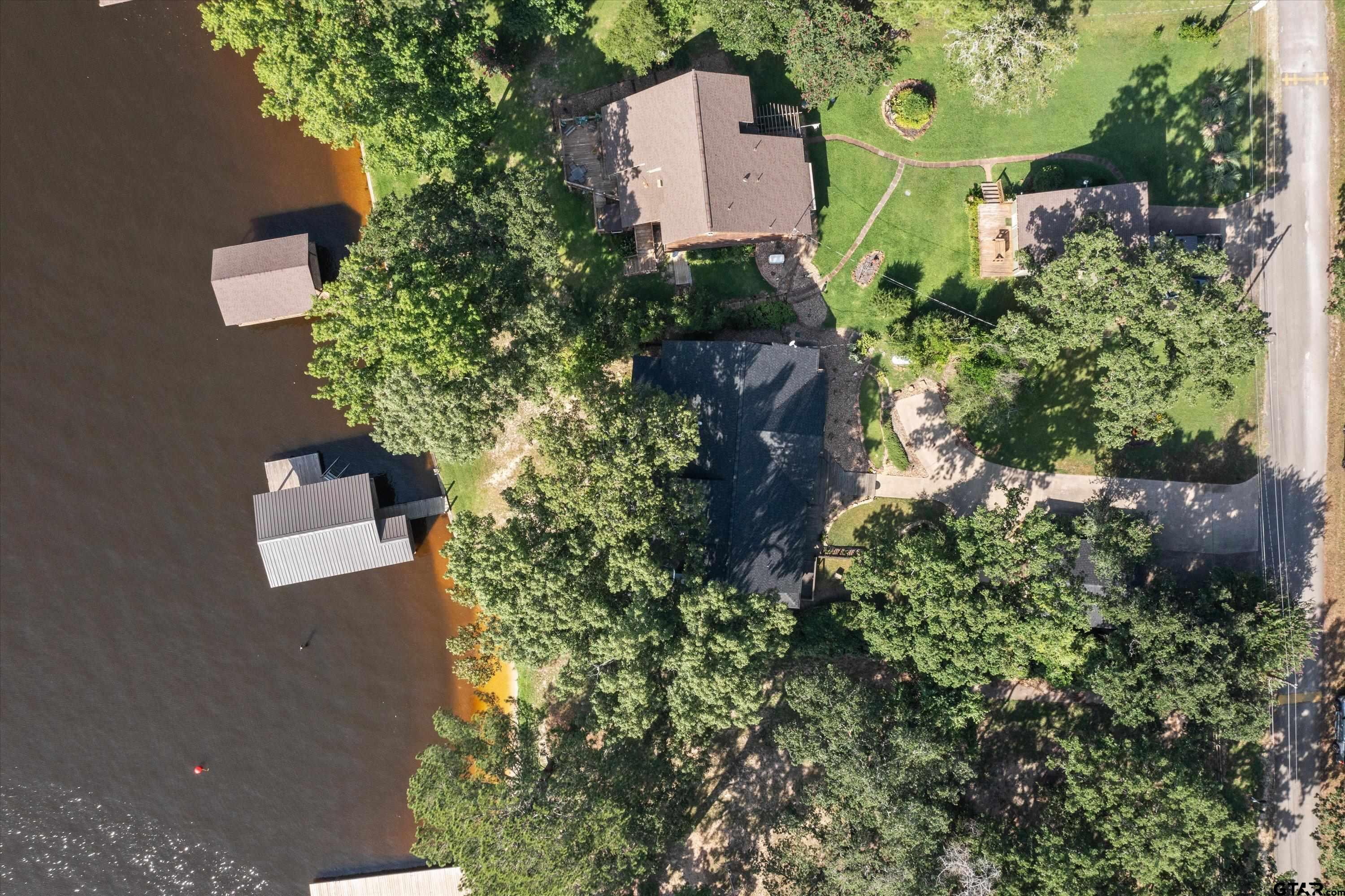129 Tejas Trail Grapeland, TX 75844 - Photo 43 of 47 an aerial view of a house with a yard and garden