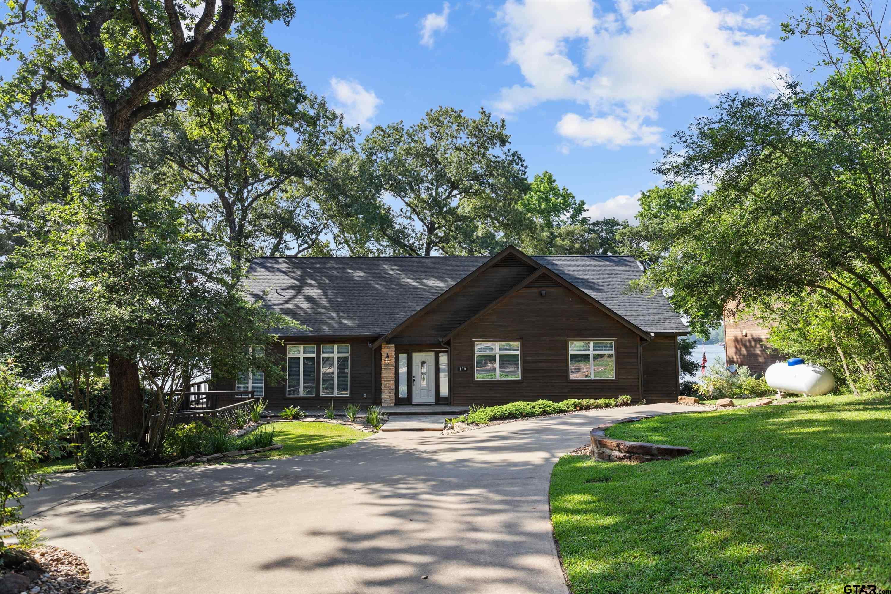 129 Tejas Trail Grapeland, TX 75844 - Photo 7 of 47 a front view of a house with a yard