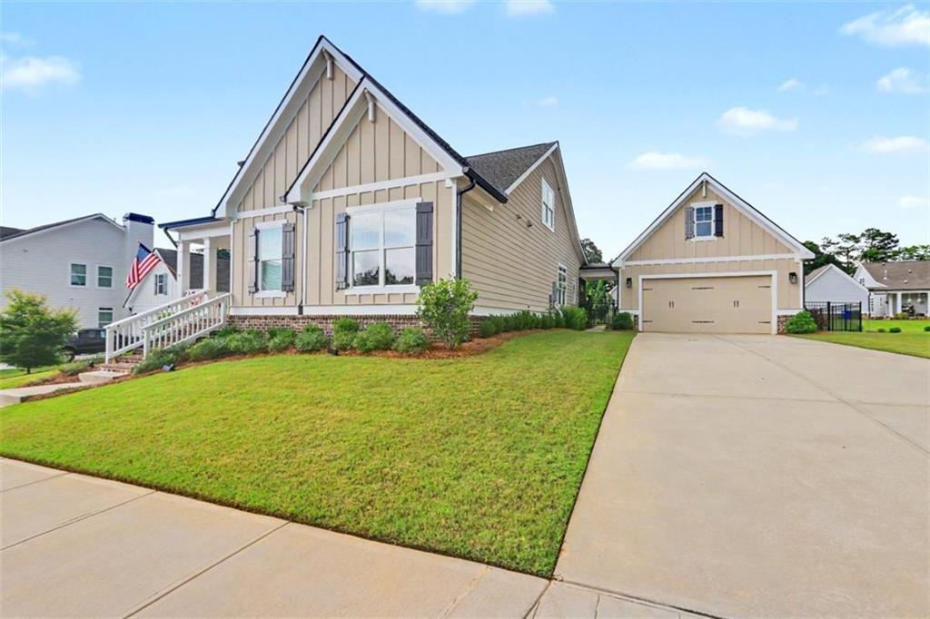 943 Clubside Drive Monroe, GA 30655 - Photo 3 of 93 a front view of a house with a yard and garage