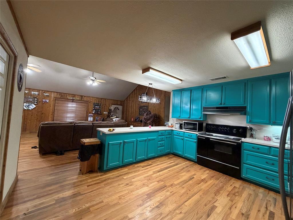 12194 Gholson Road Waco, TX 76705 - Photo 5 of 39 a kitchen with granite countertop stainless steel appliances and wooden cabinets