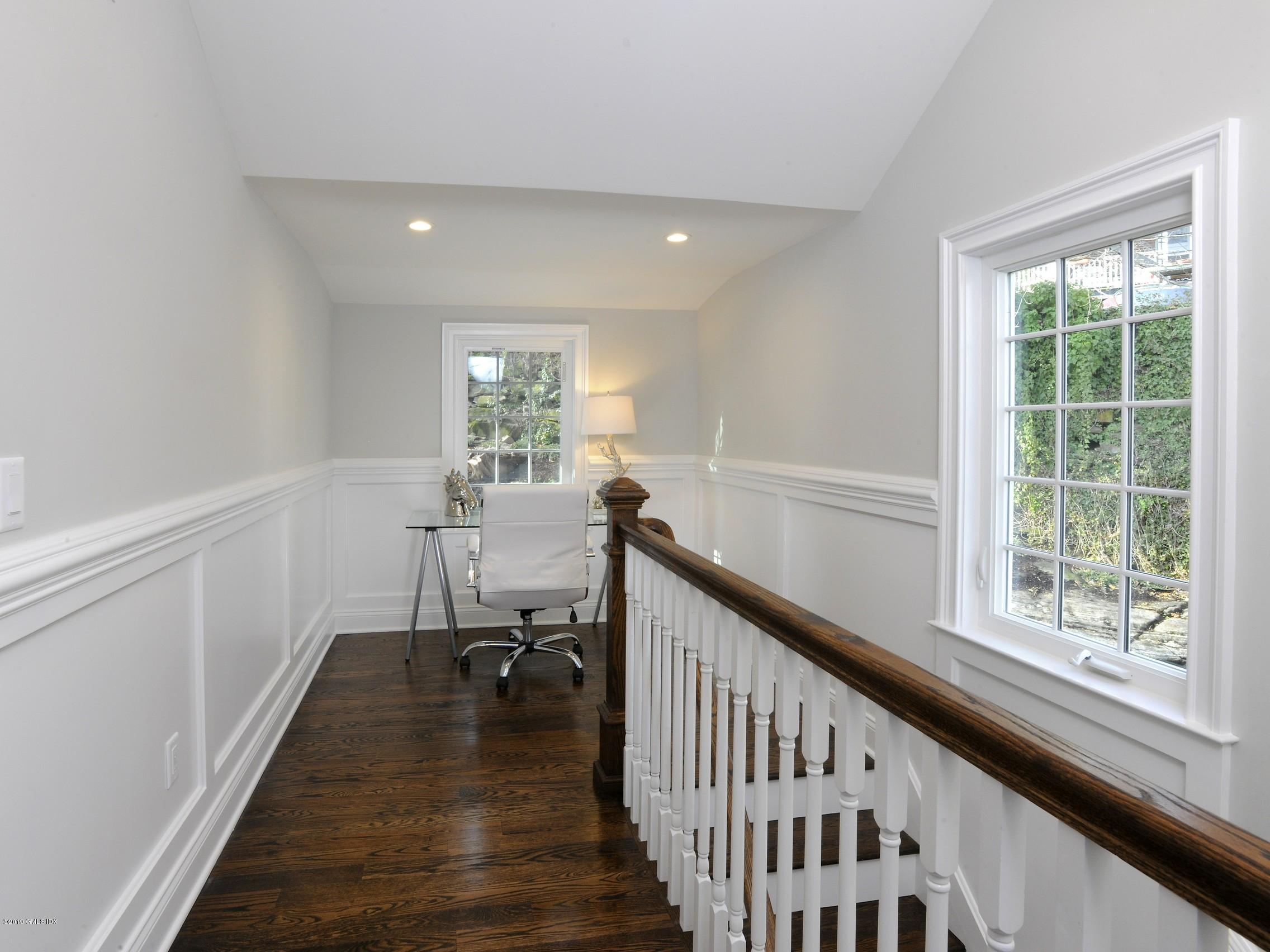 200 Davis Avenue Greenwich, CT 06830 - Photo 12 of 26 a view of a hallway with wooden floor and stairs