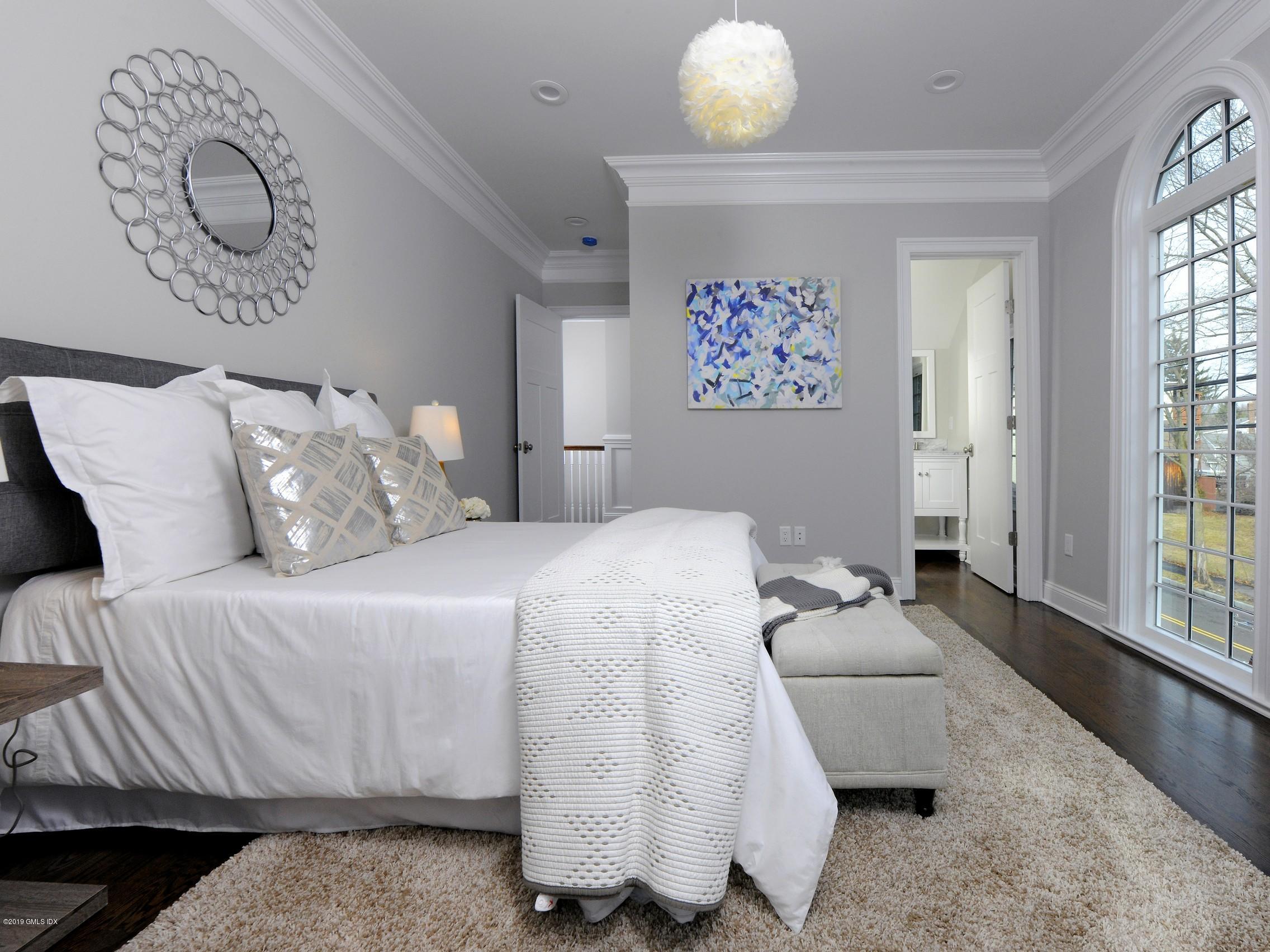 200 Davis Avenue Greenwich, CT 06830 - Photo 13 of 26 a bedroom with a bed and a large window