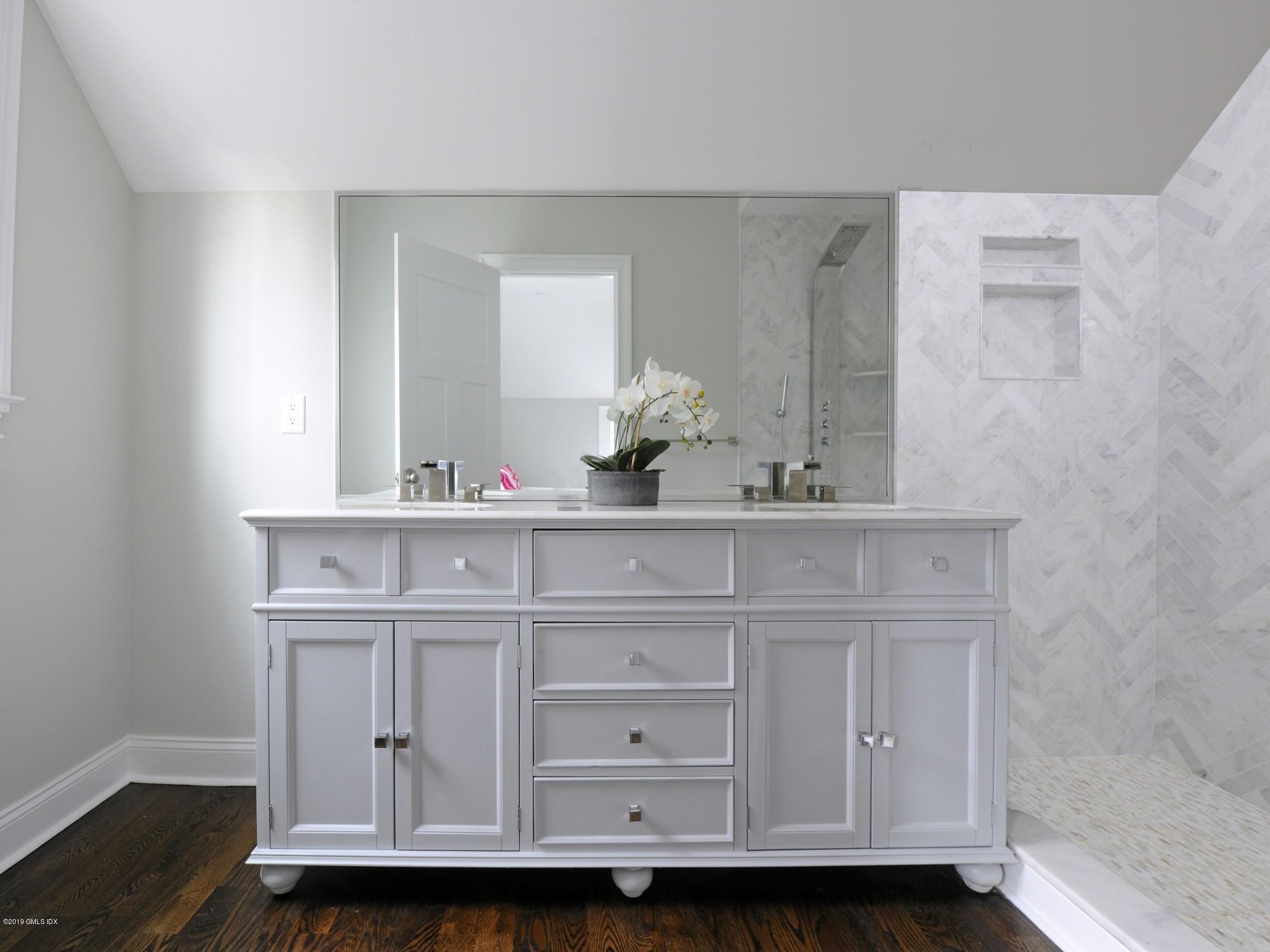 200 Davis Avenue Greenwich, CT 06830 - Photo 16 of 26 a bathroom with a sink vanity and mirror