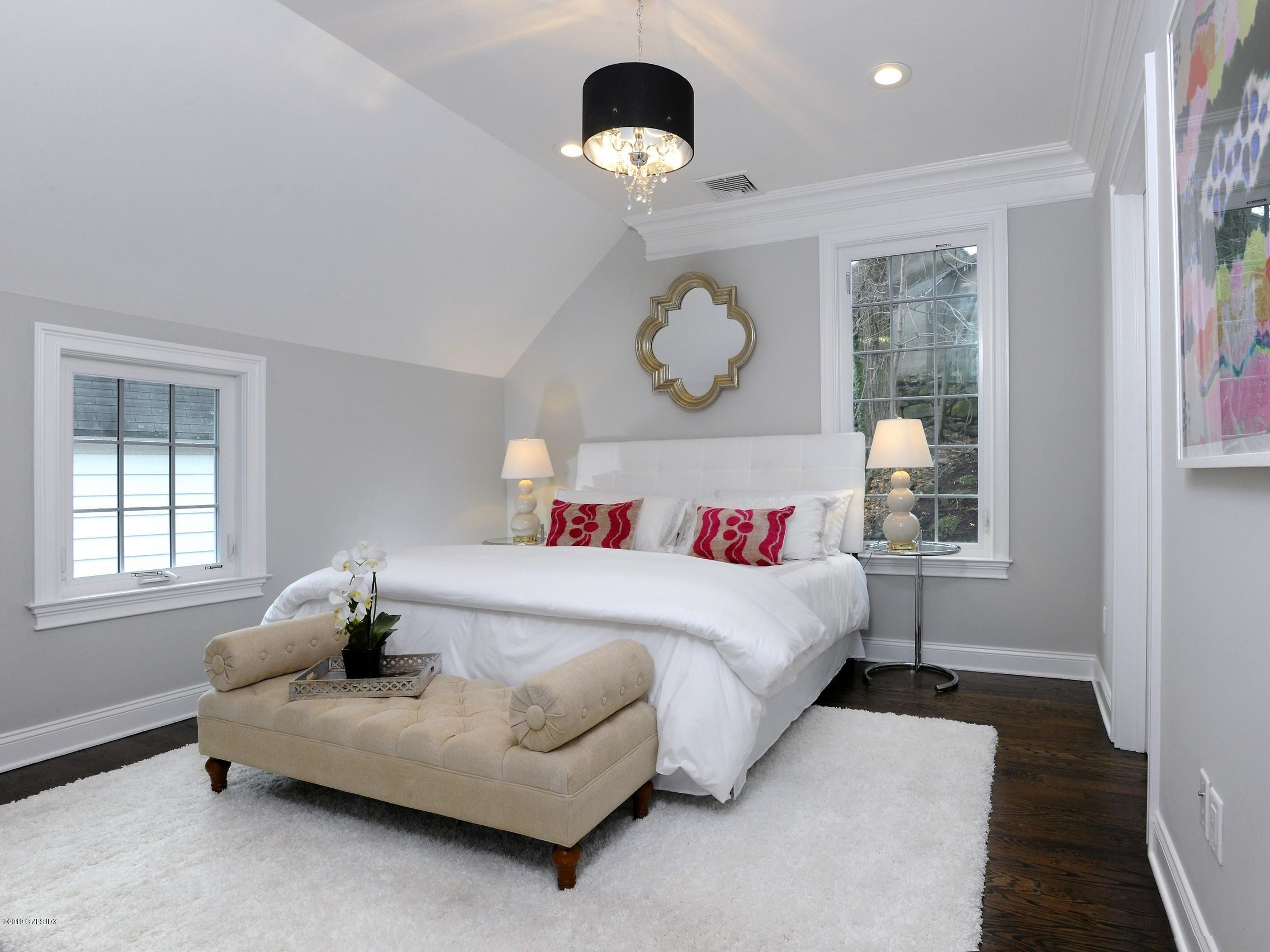 200 Davis Avenue Greenwich, CT 06830 - Photo 17 of 26 a bedroom with a bed and window