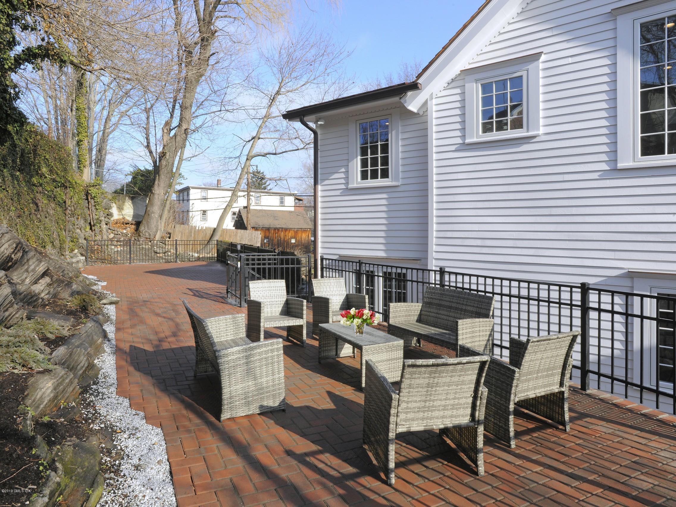 200 Davis Avenue Greenwich, CT 06830 - Photo 23 of 26 a view of a patio with a table and chairs