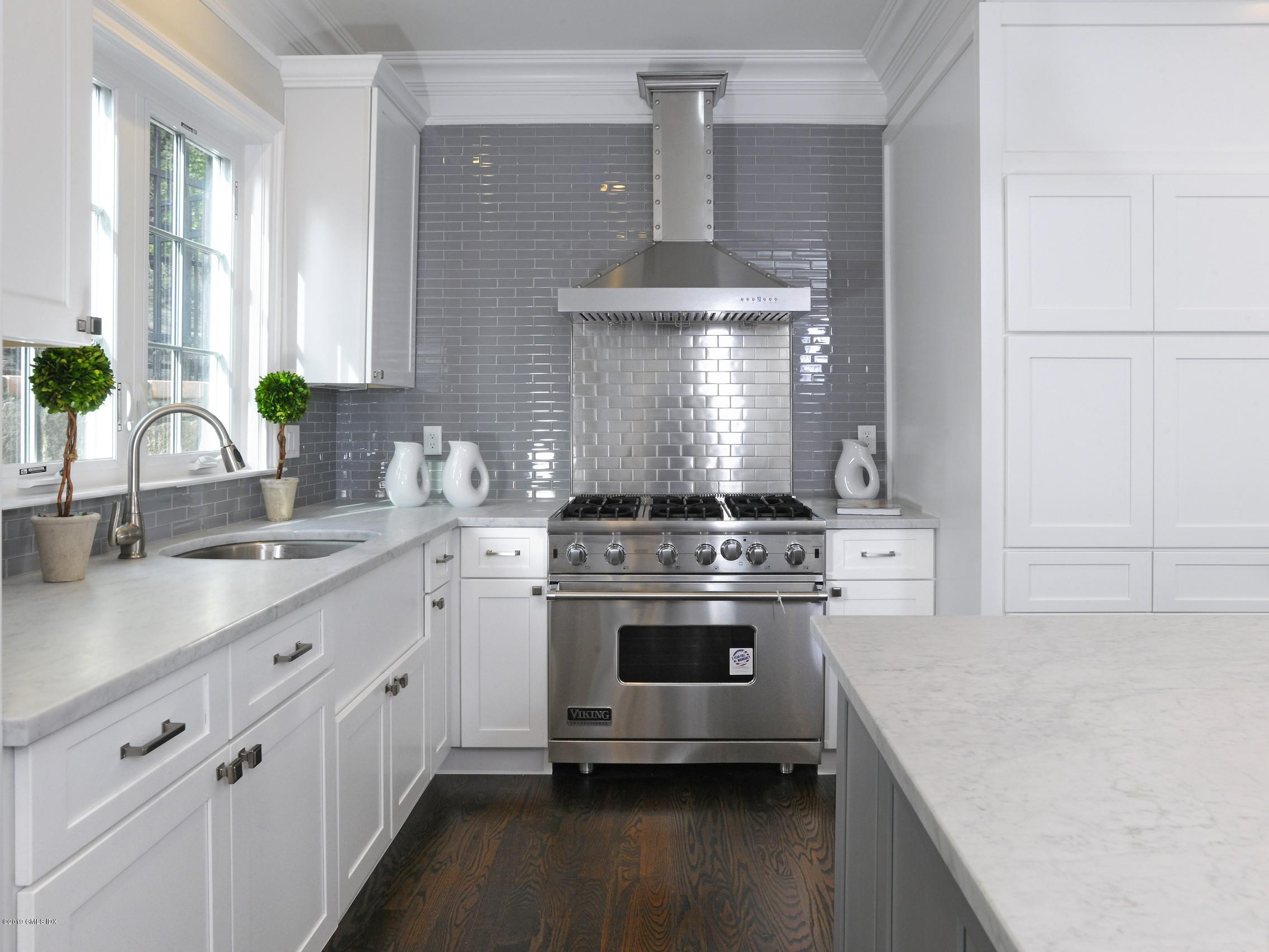 200 Davis Avenue Greenwich, CT 06830 - Photo 7 of 26 a kitchen with stainless steel appliances a sink stove and cabinets