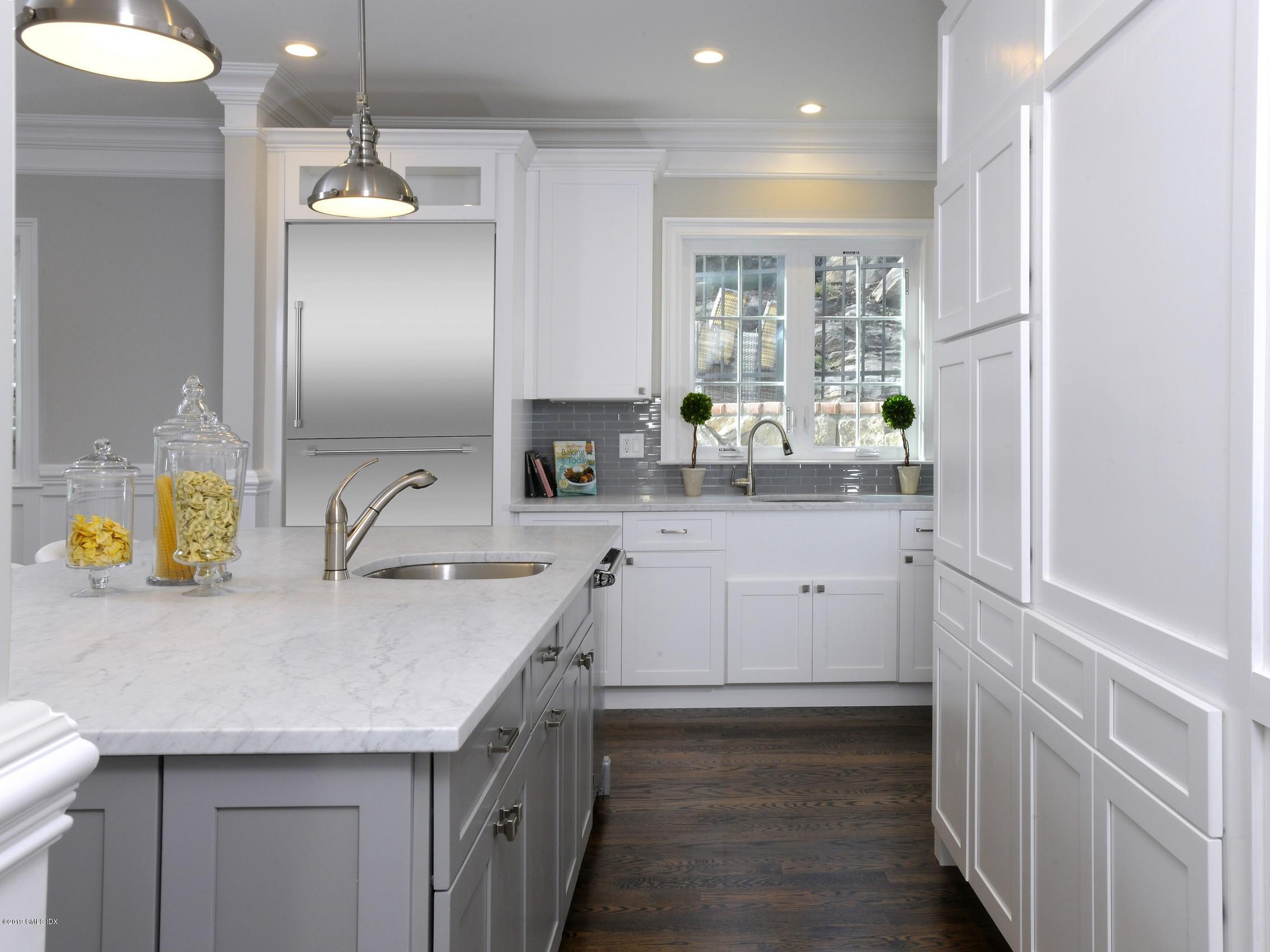 200 Davis Avenue Greenwich, CT 06830 - Photo 10 of 26 a kitchen with a sink a center island and cabinets