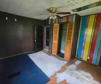 a view of a closet with wooden floor