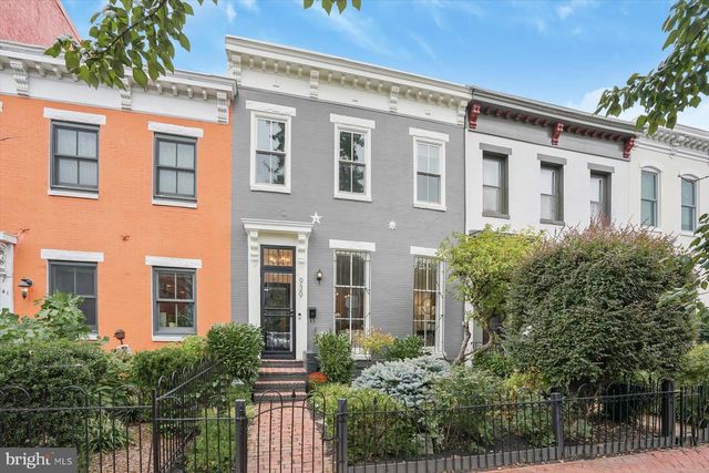 a front view of a building with a garden
