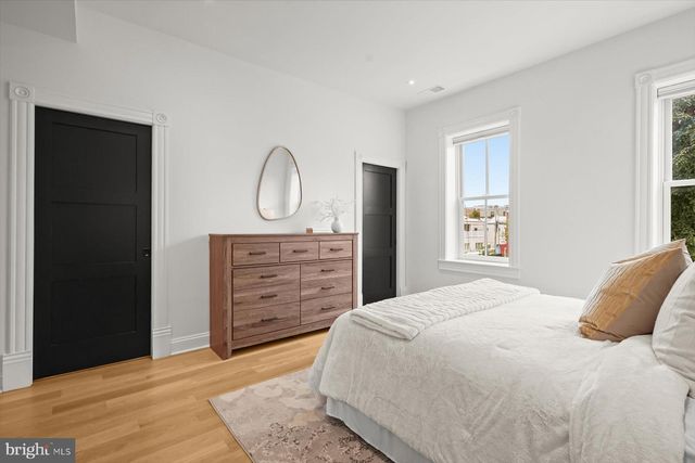 a bedroom with a bed and a dresser