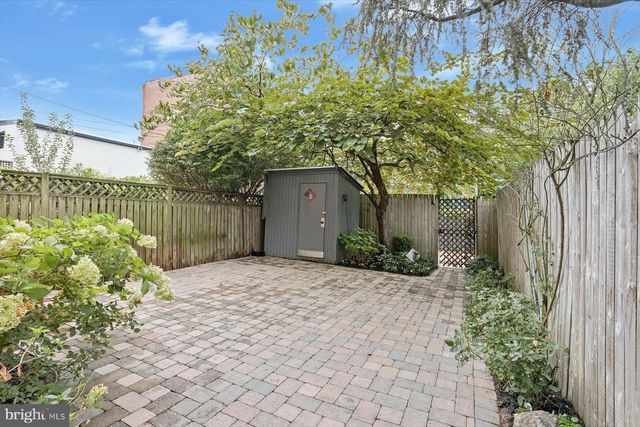 a front view of a house with a yard and plant