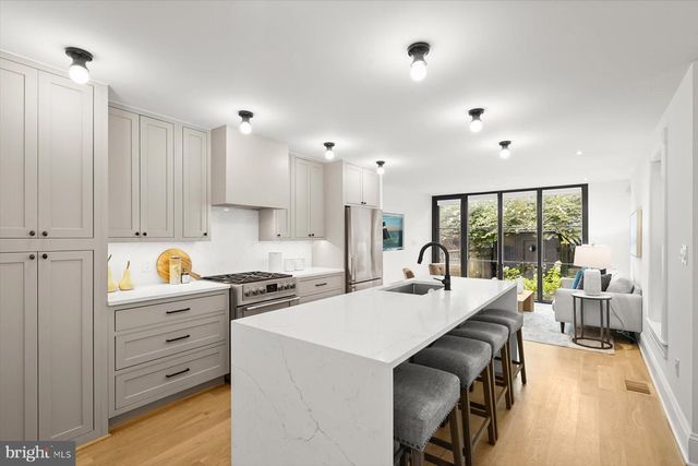 a kitchen with a table chairs stove and cabinets