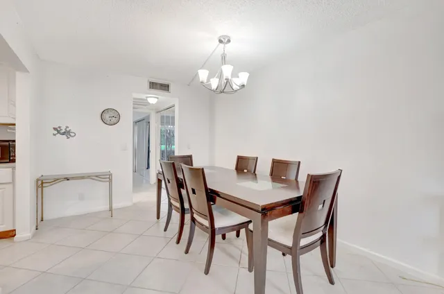 a view of a dining room with furniture and chandelier