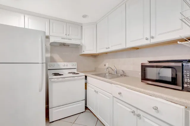 a kitchen with appliances cabinets and a counter space