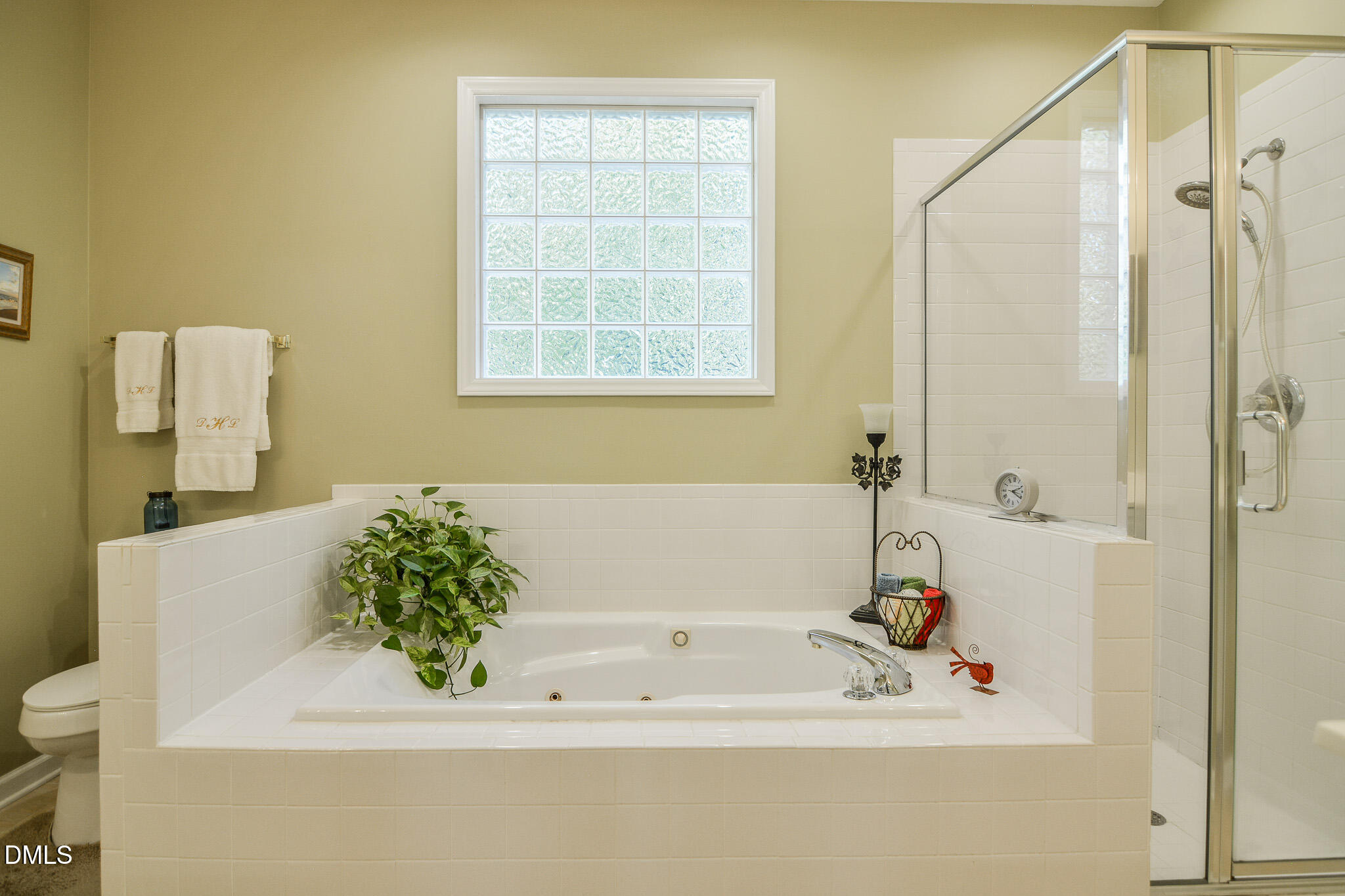 105 Trailing Oak Trail Clayton, NC 27527 - Photo 26 of 61 a bathroom with a bathtub and a shower