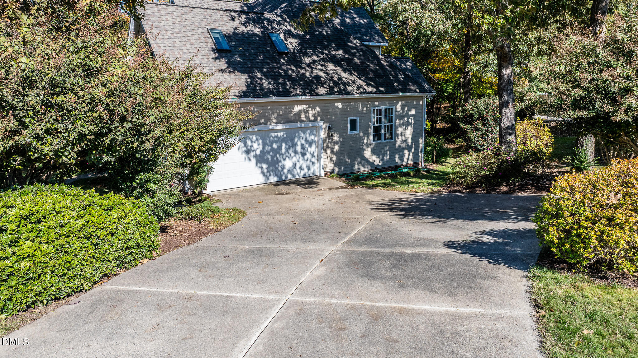 105 Trailing Oak Trail Clayton, NC 27527 - Photo 50 of 61 a view of a pathway with flower plants and wooden fence