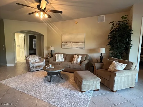 a living room with furniture and a chandelier