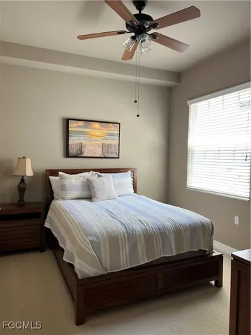 a bedroom with a bed lamp and a chandelier